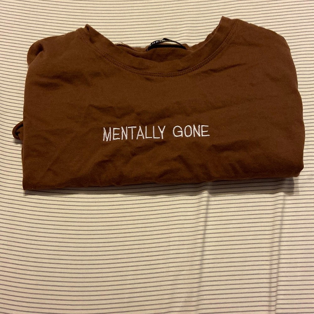 brown cropped top, says mentally gone